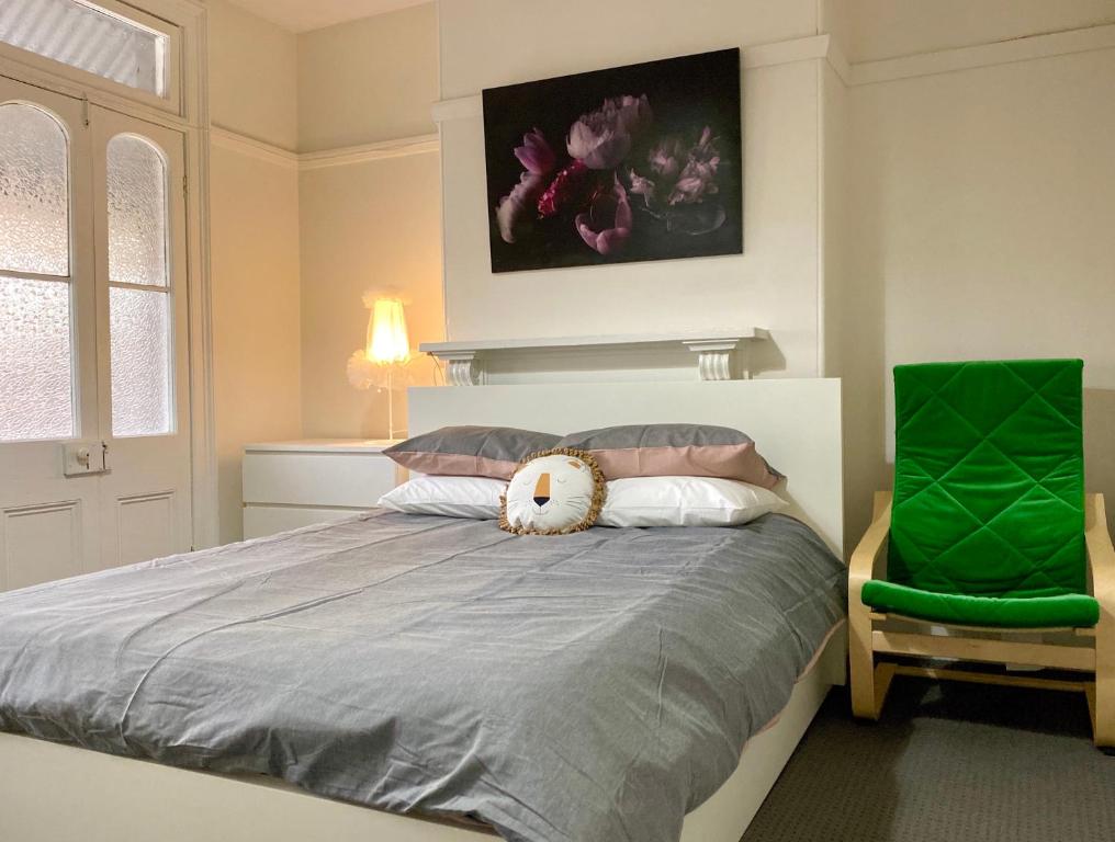 a bedroom with a bed with a stuffed animal on it at Coco’s Abode in Sydney