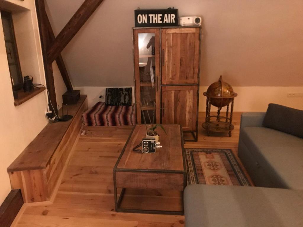 a living room with a table and a sign on the air at Cesky Krumlov centrum ap 6 in Český Krumlov