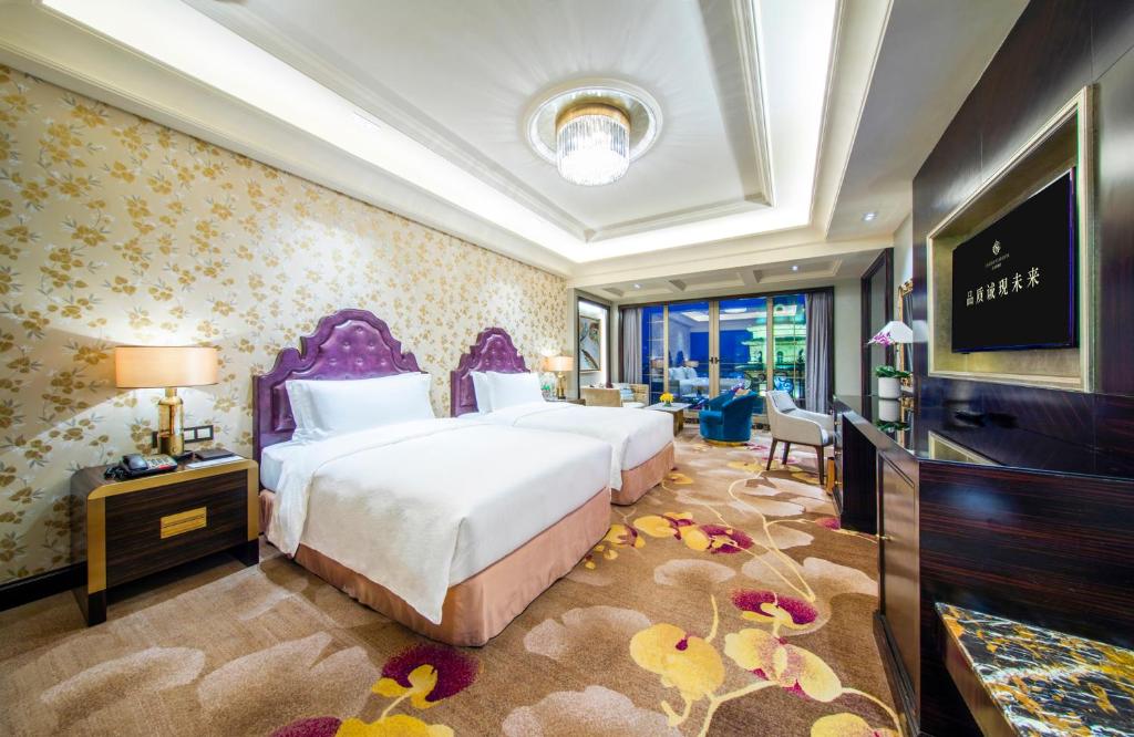 a bedroom with a large bed and a television at Chateau Star River Guangzhou-Chateau Star River Guangzhou-Trade Fair Shuttle Bus in Guangzhou