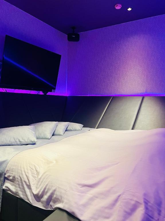 Postel nebo postele na pokoji v ubytování Asokono Hotel