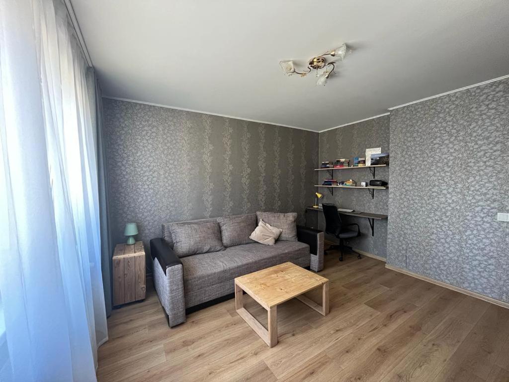 a living room with a couch and a table at Atmodas 70 in Jelgava