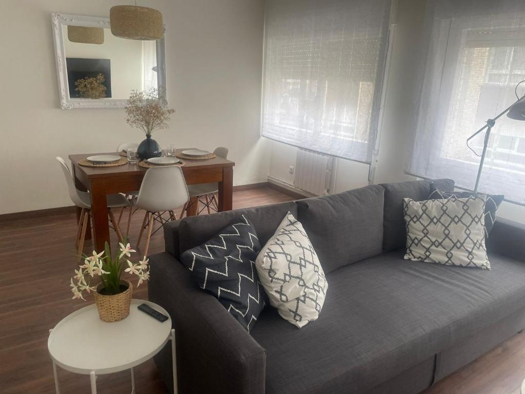 a living room with a couch and a table at BEGOÑA SUITE in Gijón