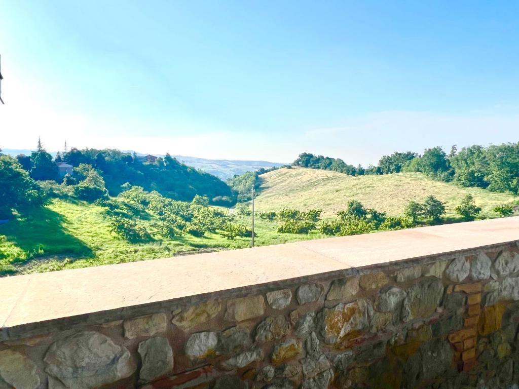 a stone wall with mountains in the background at La Rocchetta B&B in Guiglia