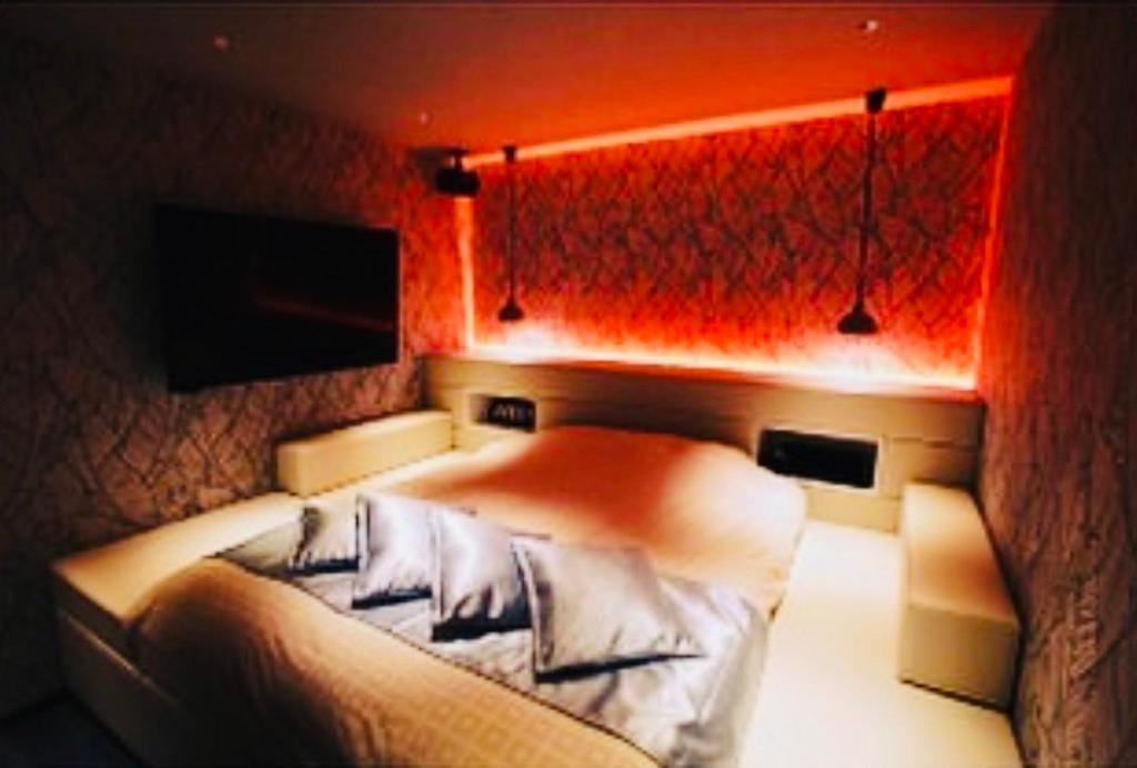 Postel nebo postele na pokoji v ubytování Asokono Hotel