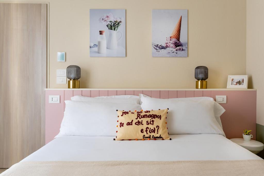 a bedroom with a white bed with a pillow on it at Pan di Zenzero in Rimini
