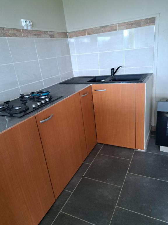 a kitchen with a sink and a stove in it at bas in Barington