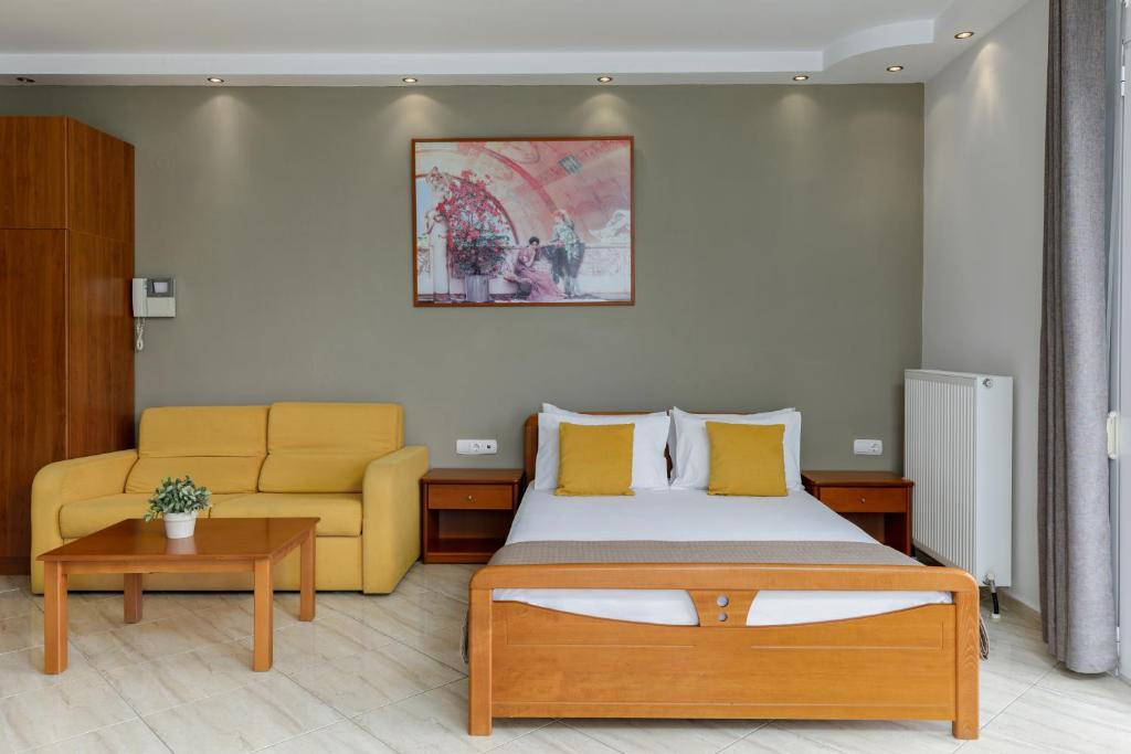 a hotel room with a bed and a couch at Agyra Seaview Hotel by Panel Hospitality in Nei Poroi