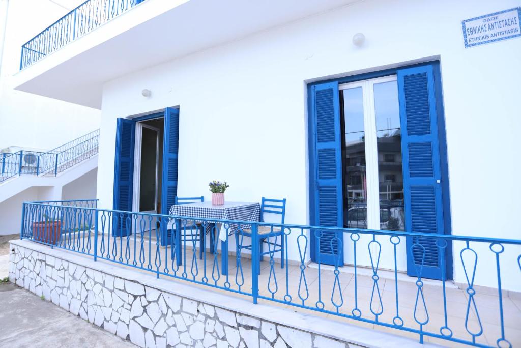 a balcony of a house with blue shutters at Rhodes Town Garden Apartment in Rhodes Town