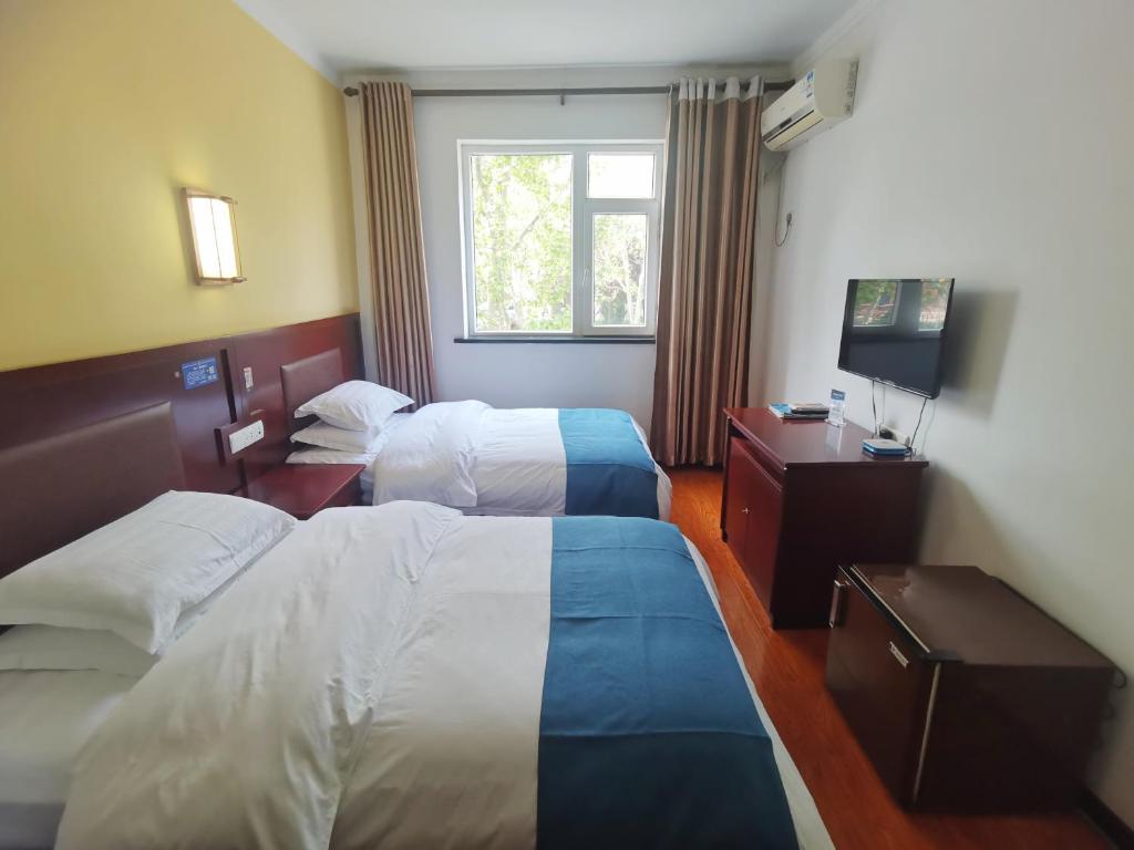 Postel nebo postele na pokoji v ubytování Beidaihe No. 3 Jinhai