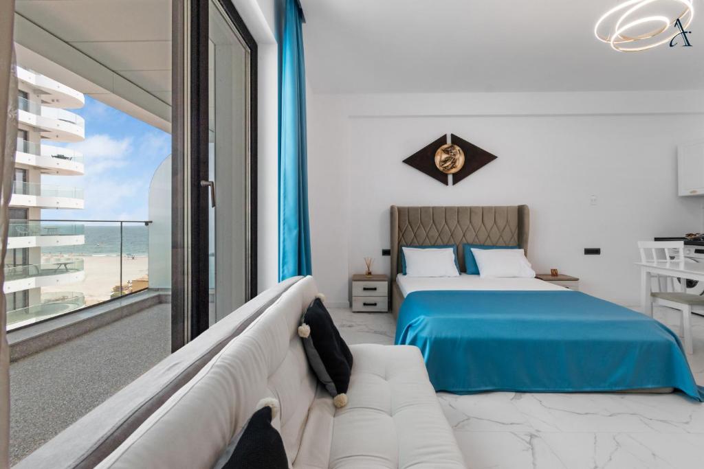 a bedroom with a bed and a view of the ocean at RentForComfort Saint George Studio & Sea View in Mamaia