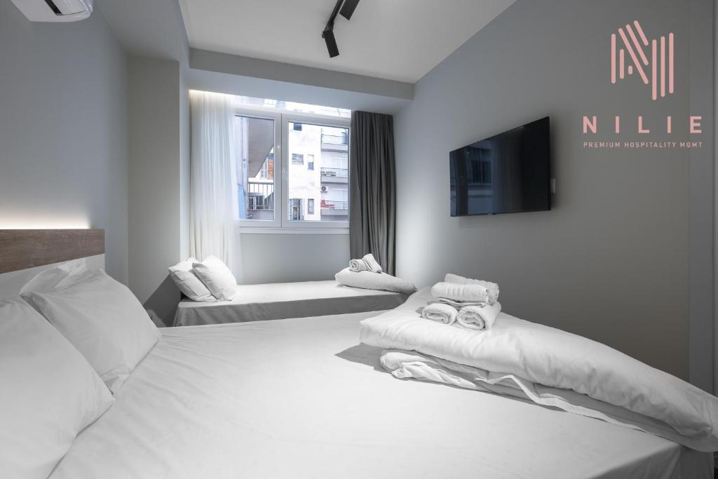 Posteľ alebo postele v izbe v ubytovaní Ultima, Nilie Hospitality MGMT