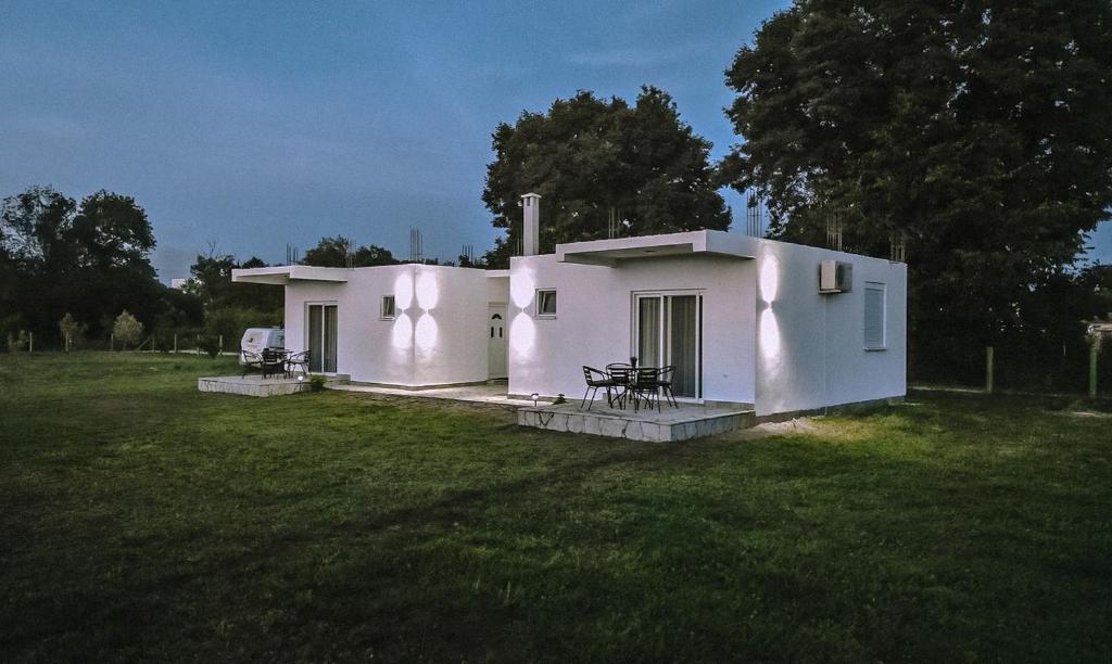 a small white house in the middle of a field at Apartmani Živanović Ulcinj in Ulcinj