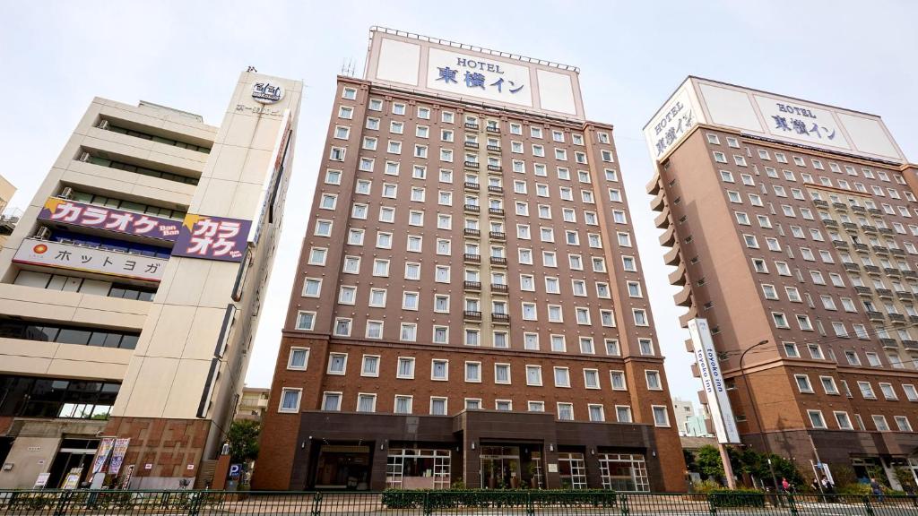 two tall buildings with a clock on top of them at Toyoko Inn Tokyo Haneda Airport No.1 in Tokyo