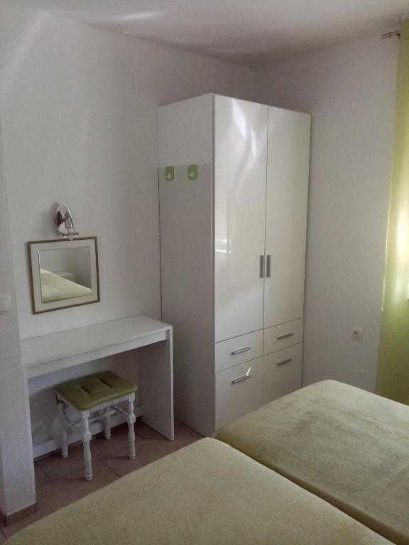 Postel nebo postele na pokoji v ubytování Apartmani Cesar