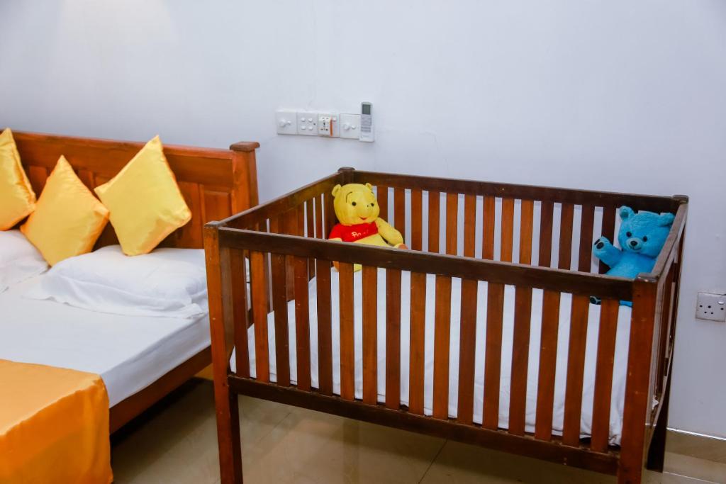 Postel nebo postele na pokoji v ubytování Ranjith Guest