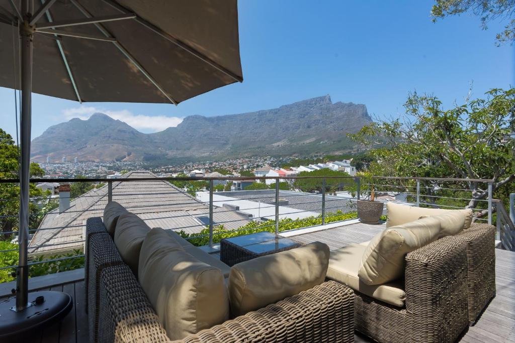 a living room with a couch and an umbrella at Albert Road 14 in Cape Town