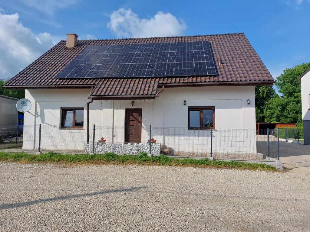 a house with solar panels on the roof at MiiG Residence Jacuzzi & Sauna Zator Oświęcim in Oświęcim
