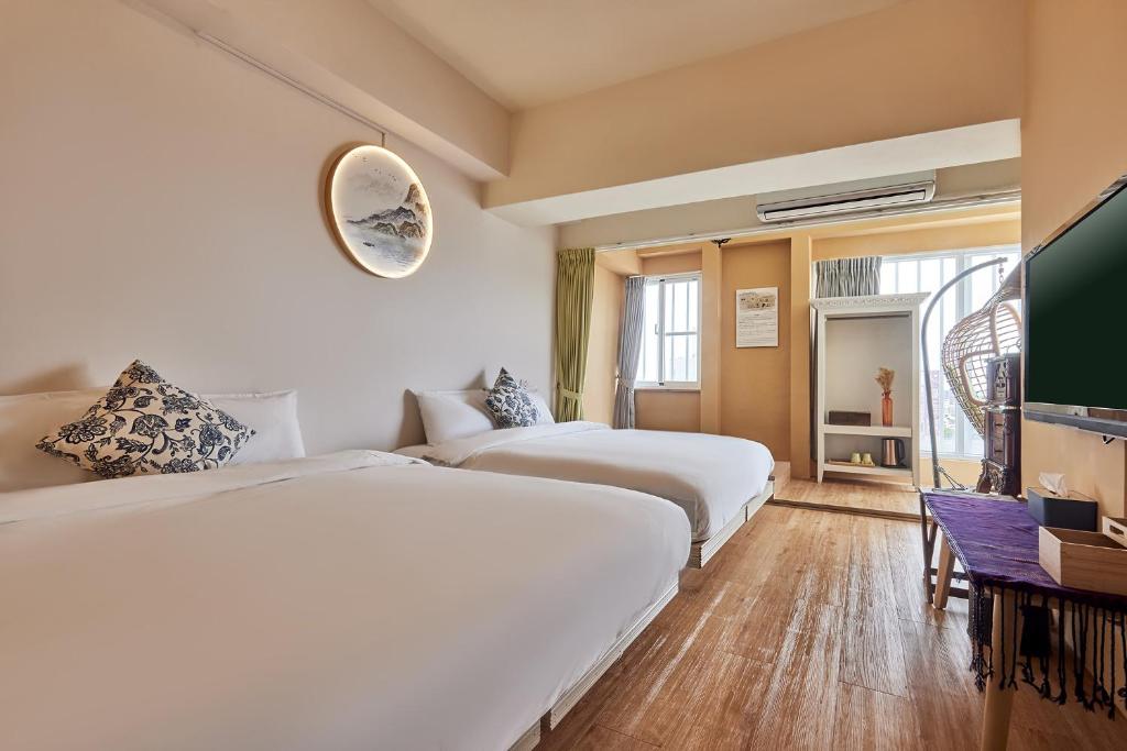 Postel nebo postele na pokoji v ubytování 安蘭居旅店 An Lan Jie Hotel