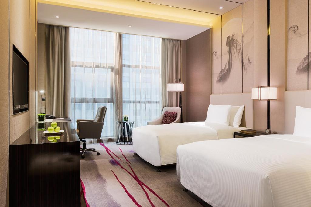 Postel nebo postele na pokoji v ubytování Maanshan Wanda Realm Hotel