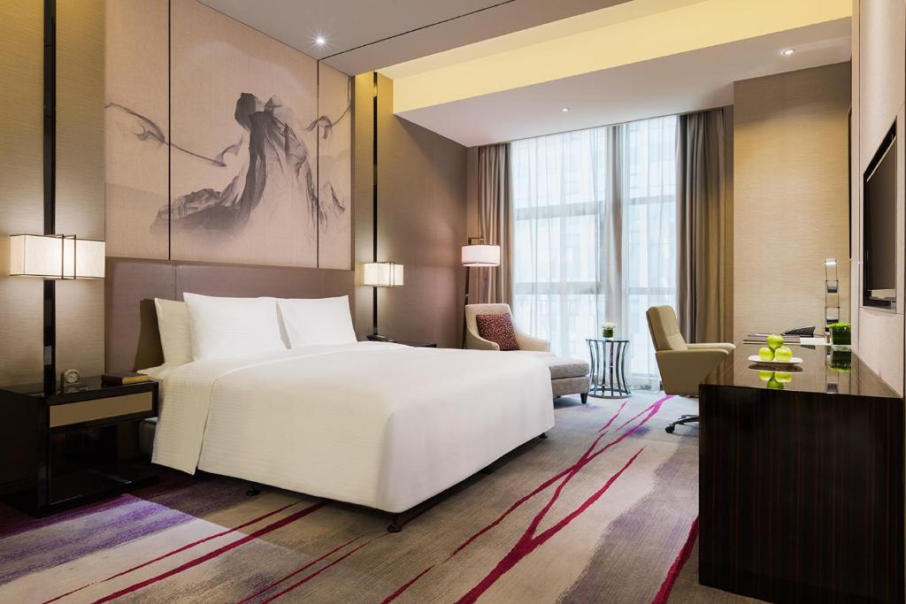 Postel nebo postele na pokoji v ubytování Maanshan Wanda Realm Hotel