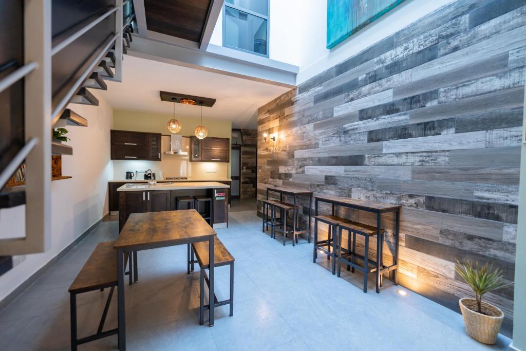 a kitchen with wooden walls and wooden tables and chairs at Entire house 3 bedrooms in Victoria