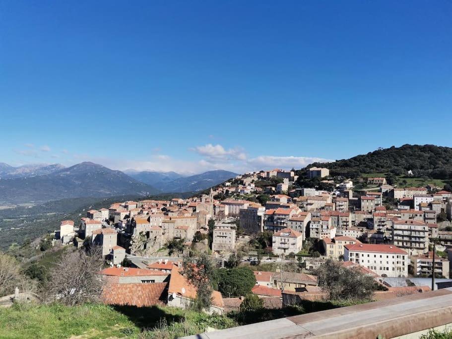 a view of a town on a hill at Entre Mer et Montagne in Sartène