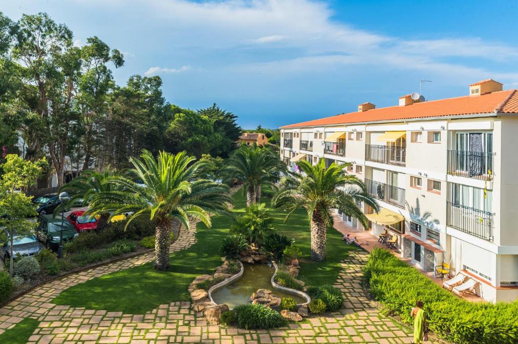 an aerial view of a resort with palm trees at AO-6 Calella de Palafrugell 2 PAX in Calella de Palafrugell