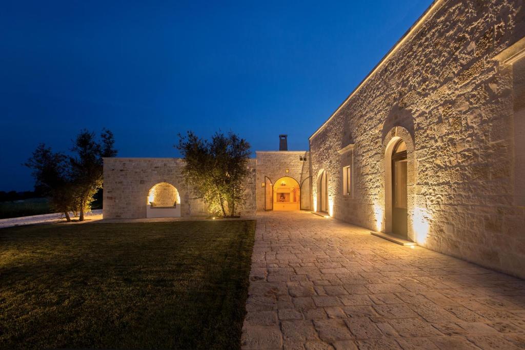 an alleyway leading to a building at night at Ddò Relais di Puglia in Ostuni