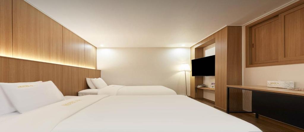 Postel nebo postele na pokoji v ubytování Hotel Q Chuncheon
