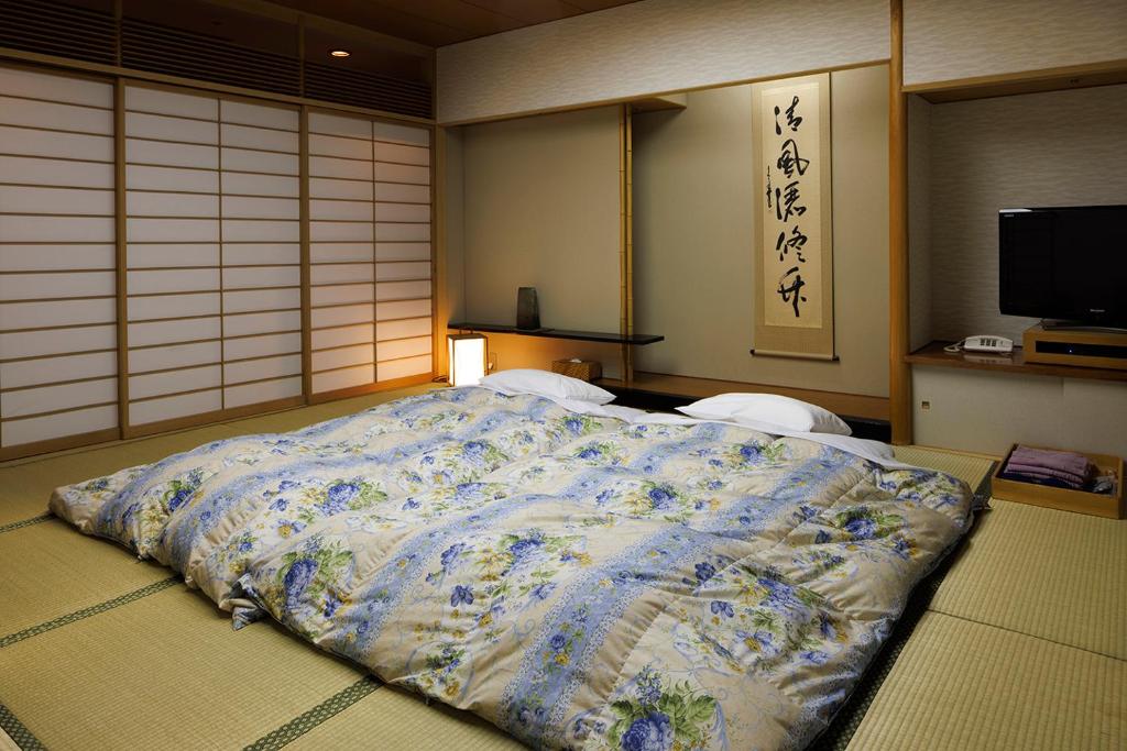 Postel nebo postele na pokoji v ubytování Yumoto Fujiya Hotel