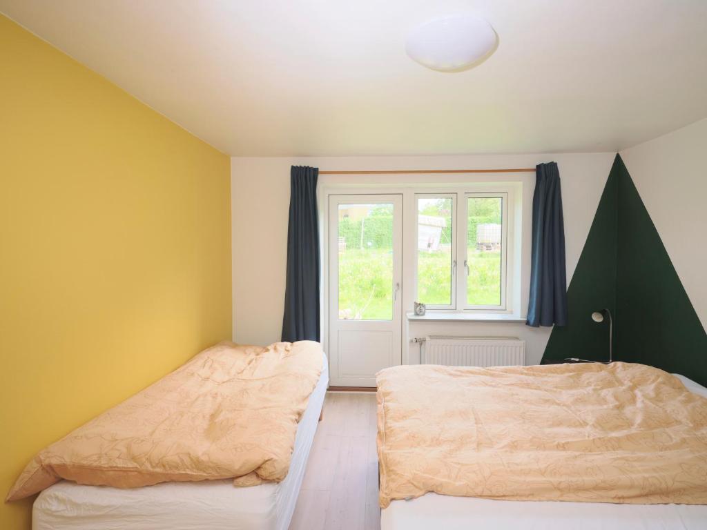 Postel nebo postele na pokoji v ubytování Vinkelgaard