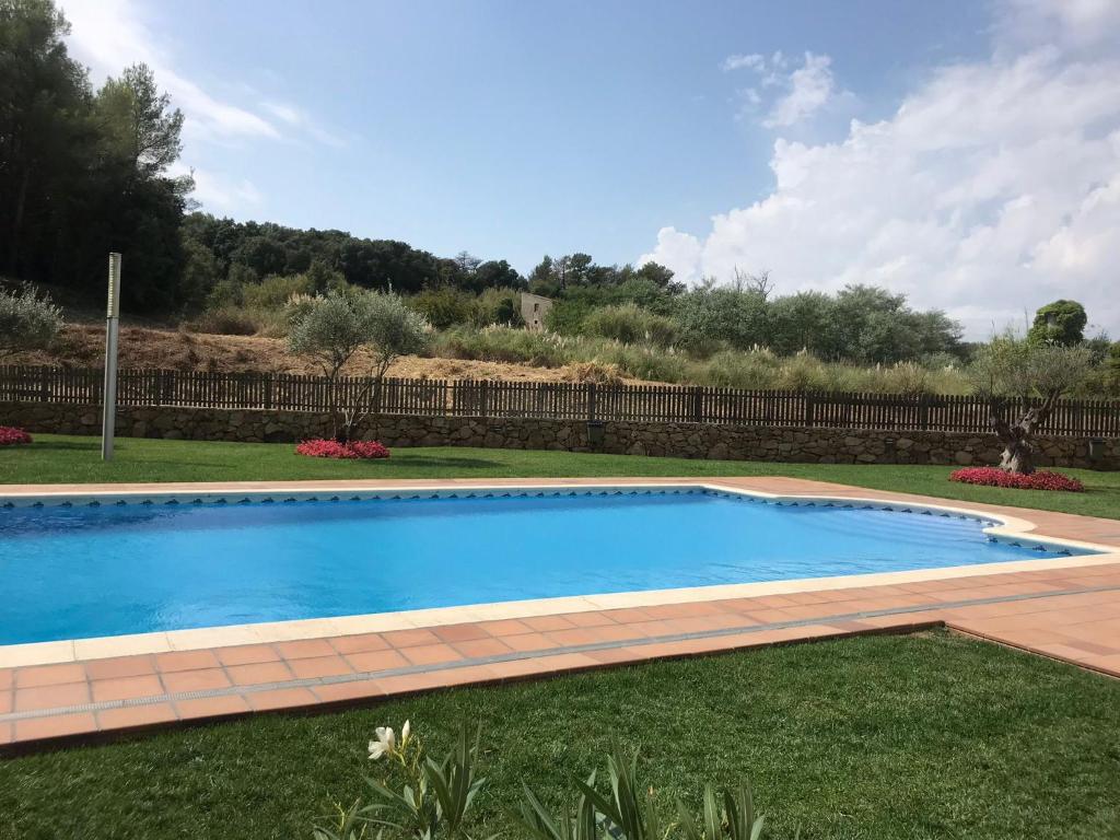 a swimming pool in the middle of a yard at Sa Boadella - Fenals Beach in Lloret de Mar