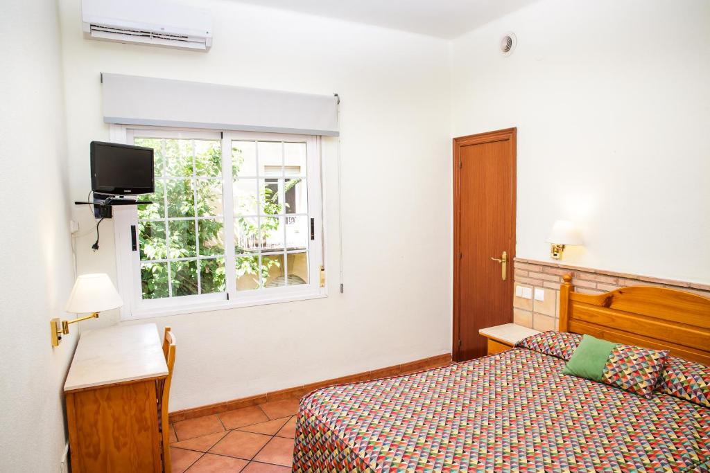 Postel nebo postele na pokoji v ubytování Hotel Can Solé
