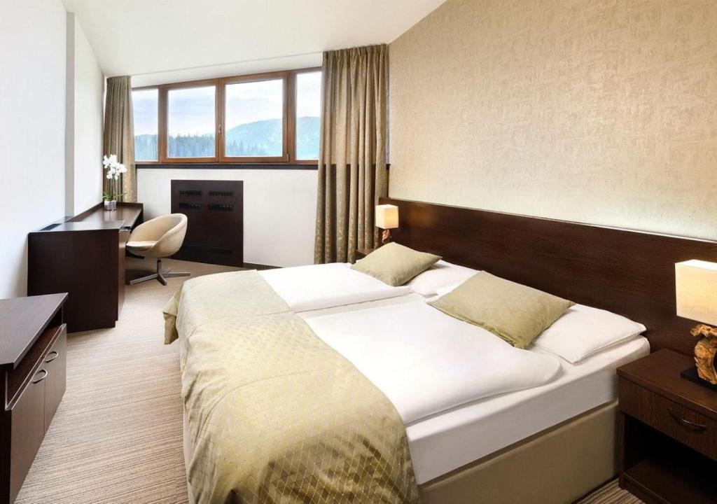 Postel nebo postele na pokoji v ubytování Hotel Grand Jasná