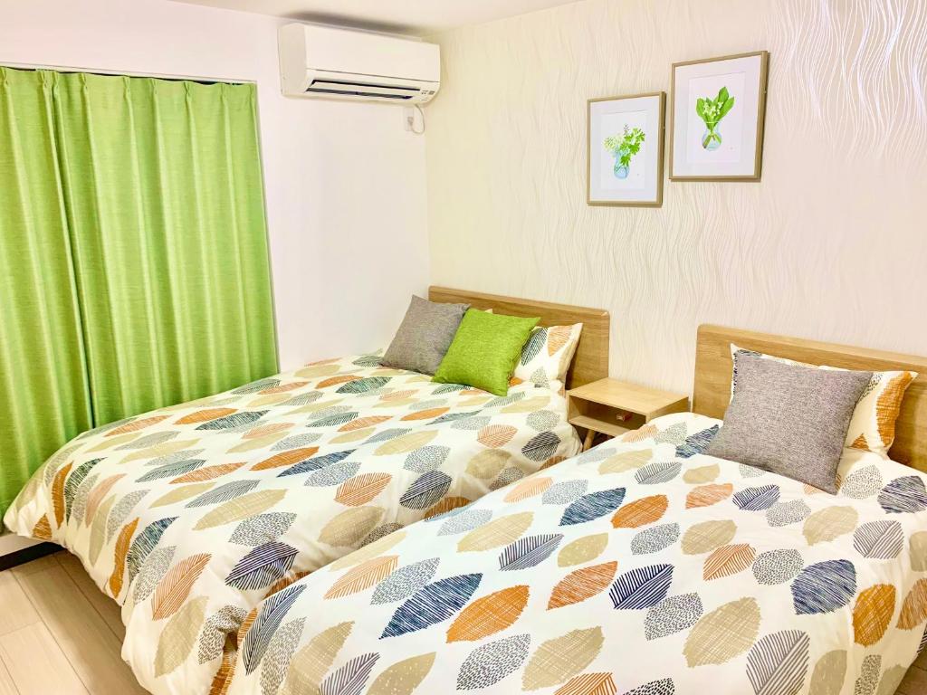 a bedroom with a bed and a green curtain at ＊大阪＊一棟貸切、駅から徒歩3分、複数駅利用可、電車で梅田まで5分、地下鉄でなんばまで9分 in Osaka