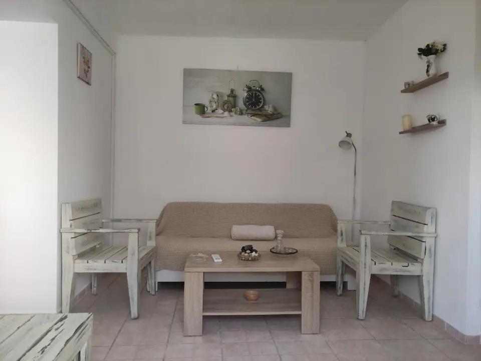 a living room with a couch and two tables at Argyro's vintage House in Spílion