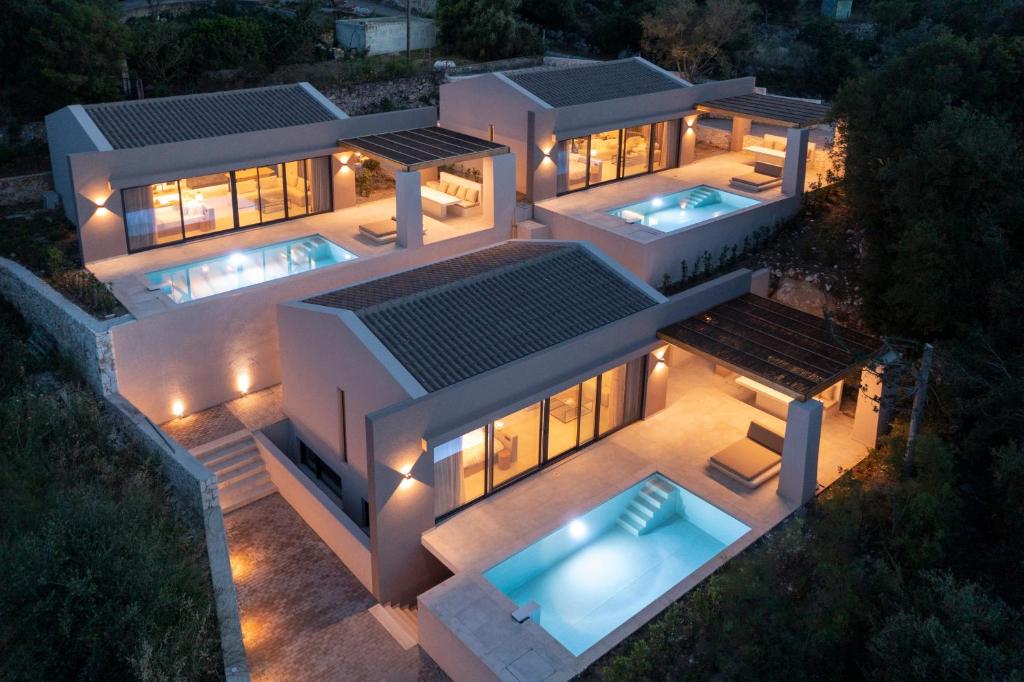 een luchtzicht op een huis 's nachts met verlichting bij Amahle Luxury Villas 2023 in Andipáta Erísou