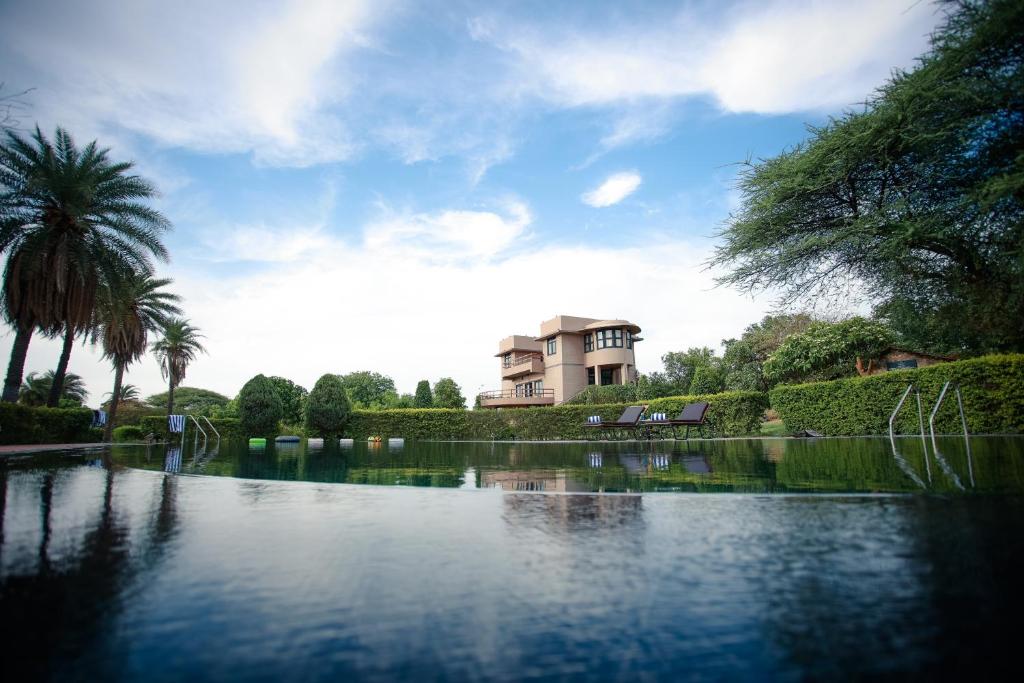 a view of a lake with a building in the background at Clarks Safari Pushkar in Pushkar