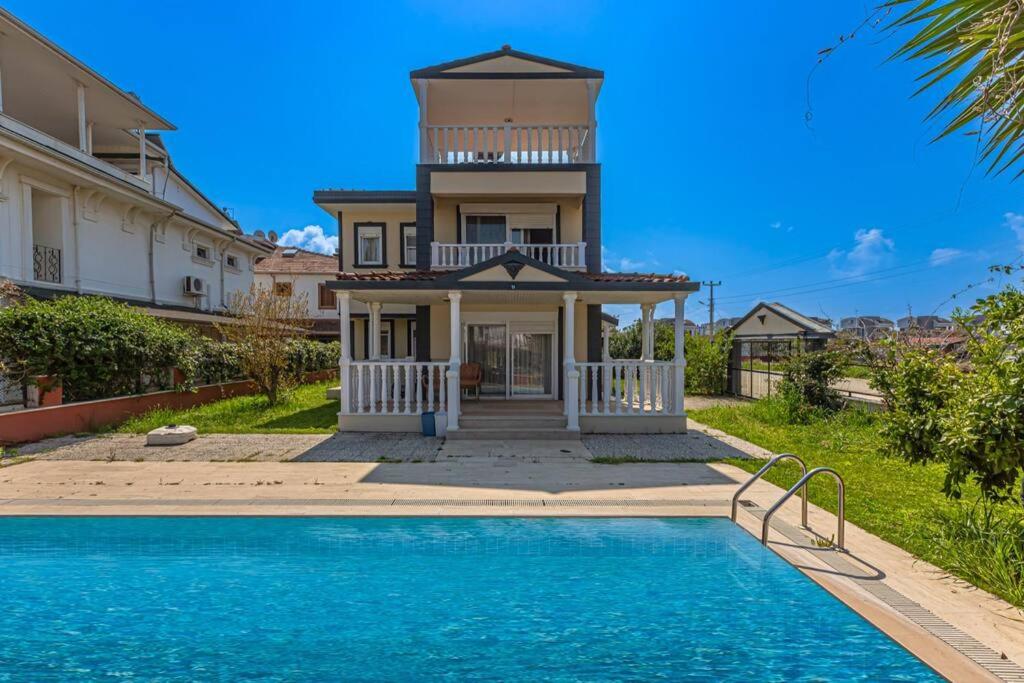 a house with a swimming pool and a lighthouse at Private Pool,near to The Land of LEGEND in Belek