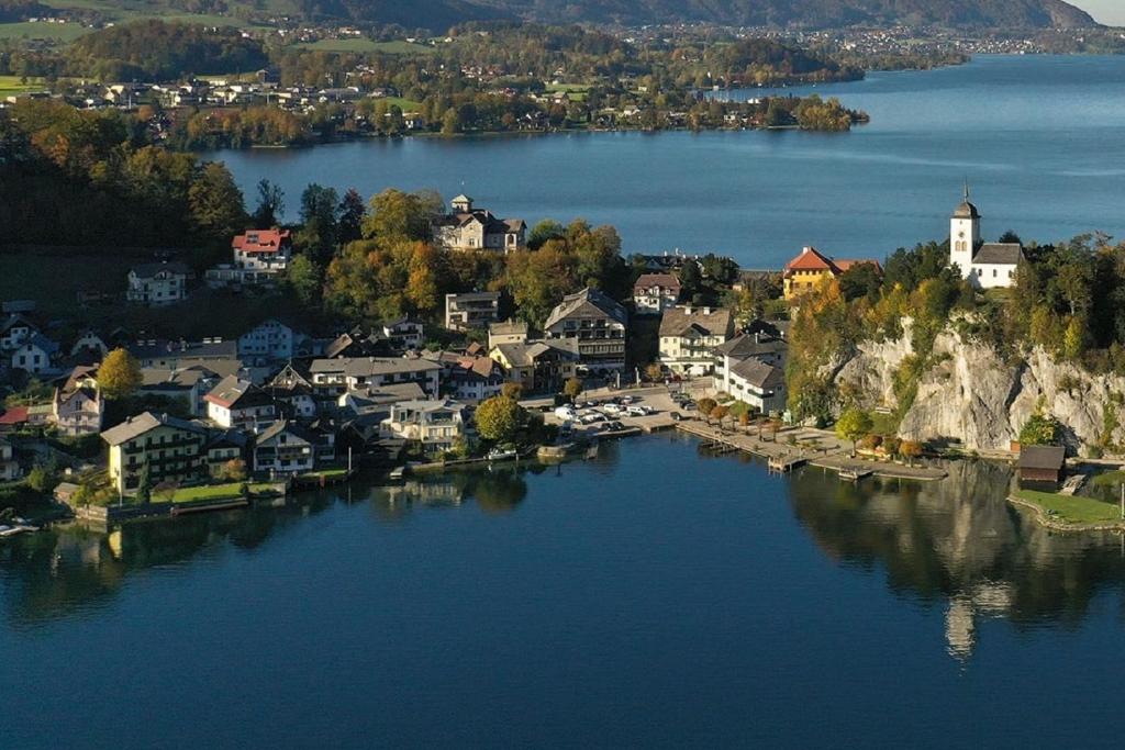 an aerial view of a small town on a lake at POST AM SEE in Traunkirchen