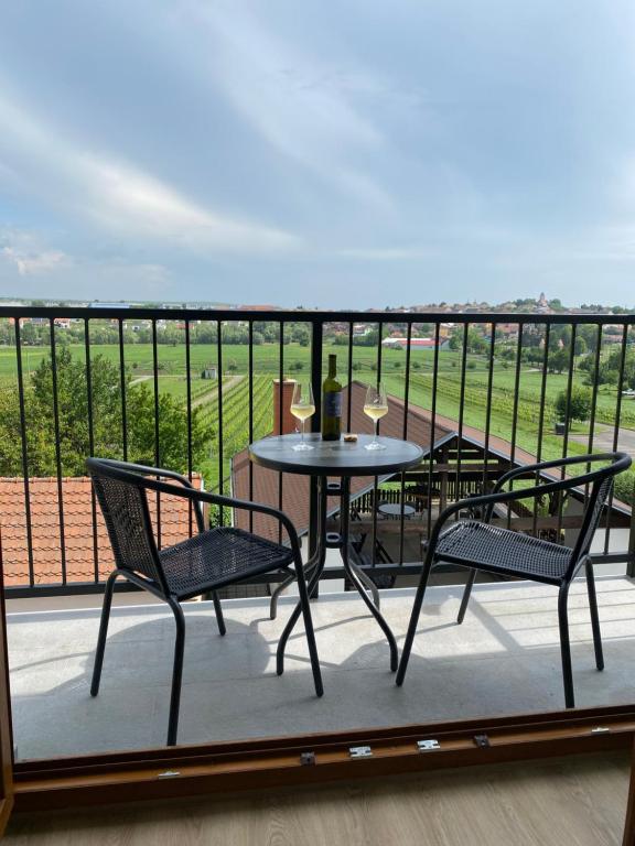 a table and chairs on a balcony with a view at Friends in Bořetice