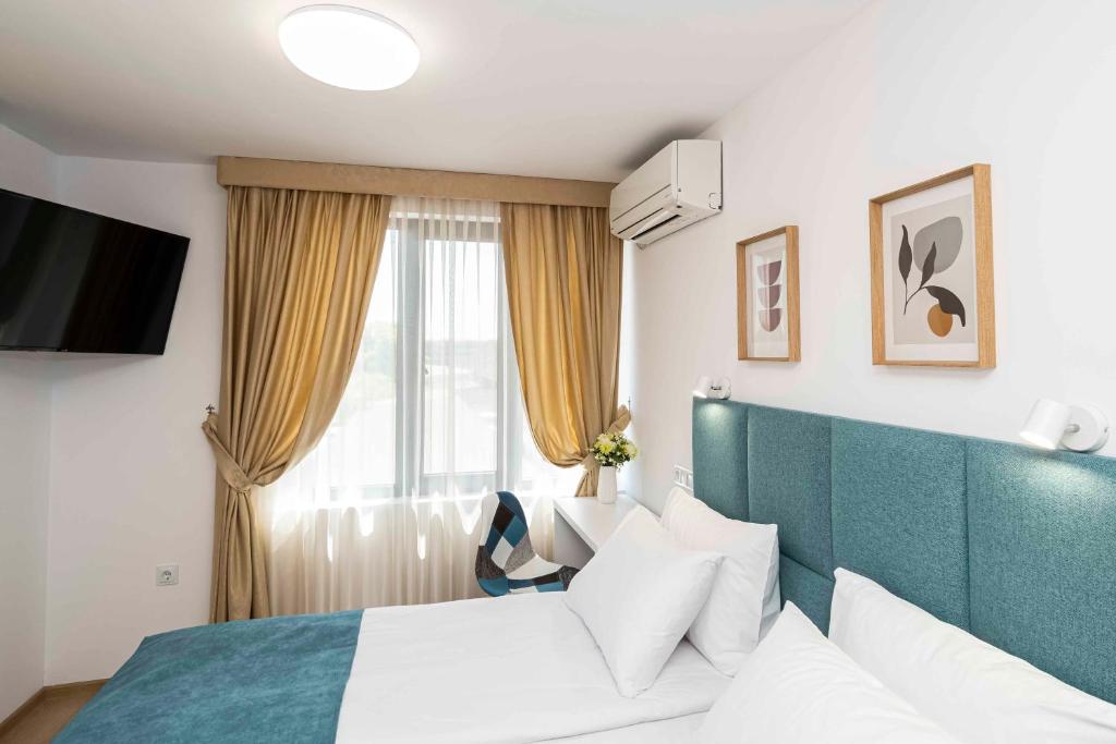 a hotel room with a bed and a window at Електра Апарт Бургас Electra Apart Burgas Elektra Bourgas in Burgas City