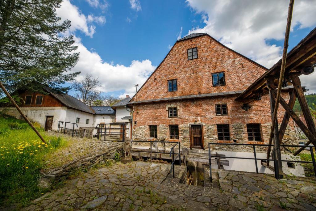 a large brick building with a fence in front of it at Vodní mlýn Wesselsky in Odry