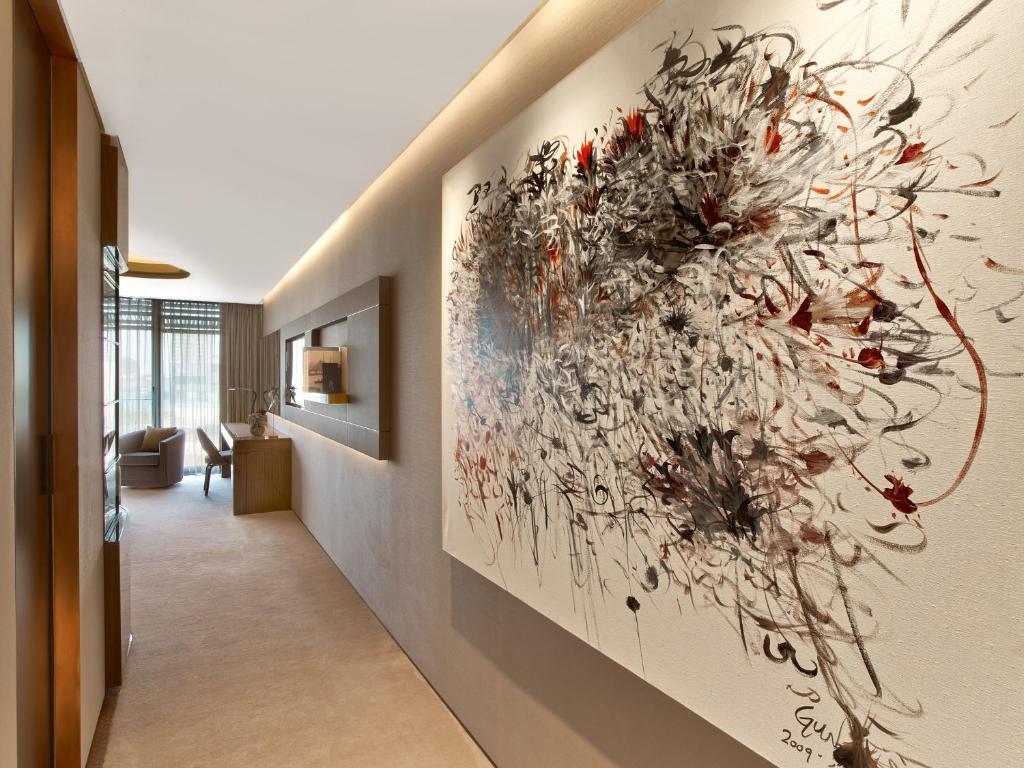 a hallway with a large painting on the wall at The St. Regis Istanbul in Istanbul