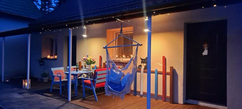 a room with a table and a swing at Dom Pracy Twórczej Macondo 