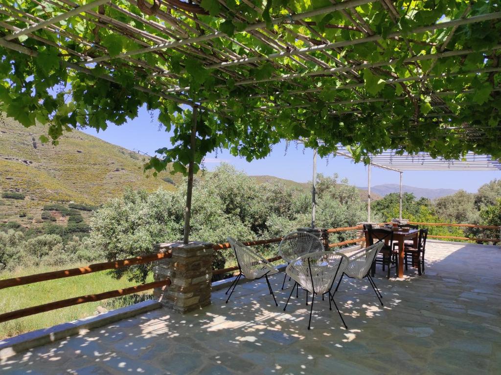 a patio with chairs and a table with a view at Ktima Kariofillis in Révmata