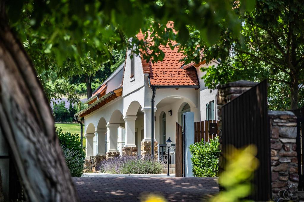 a white house with a red roof at Oszter Udvarház in Kékkút