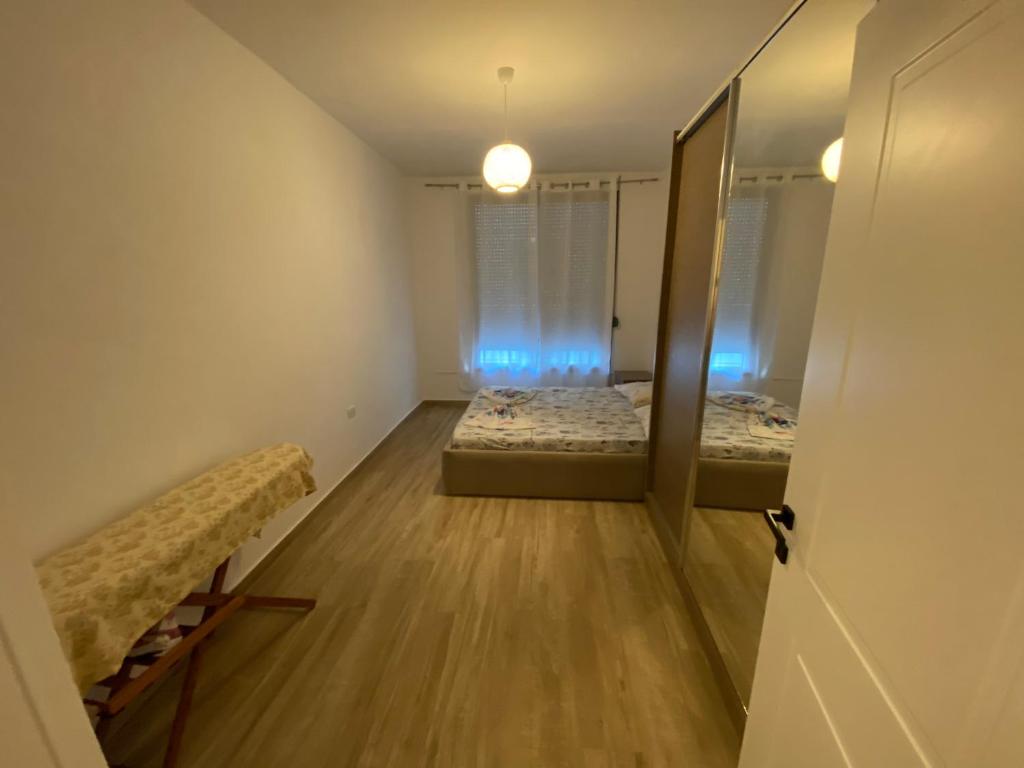 um quarto vazio com duas camas e um espelho em Oniss Apartment em Golem