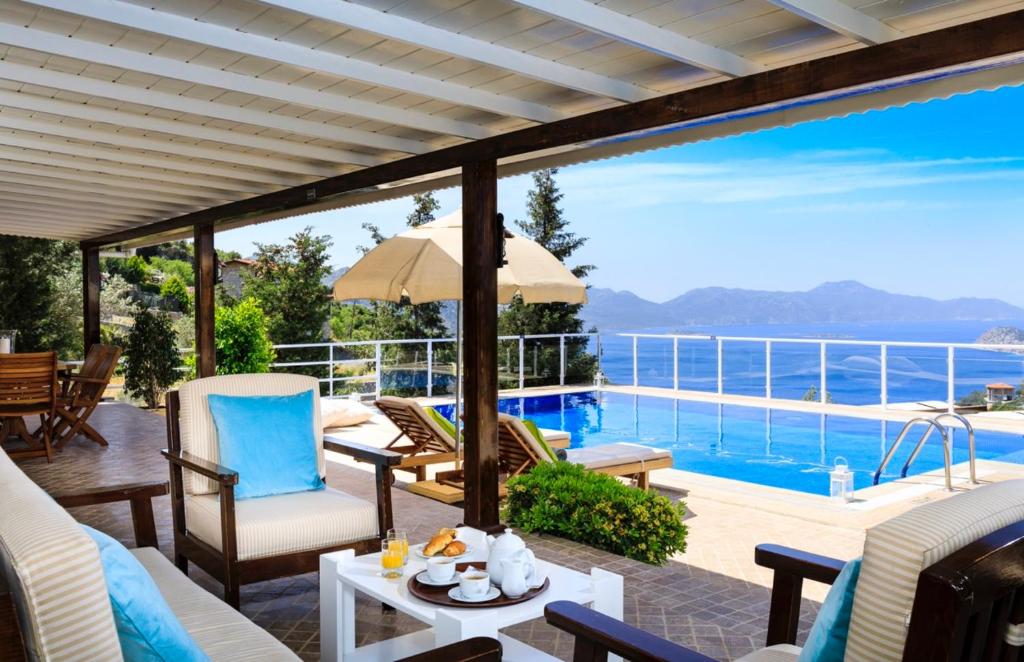 a patio with a view of a swimming pool at Zeytin Evi in Marmaris
