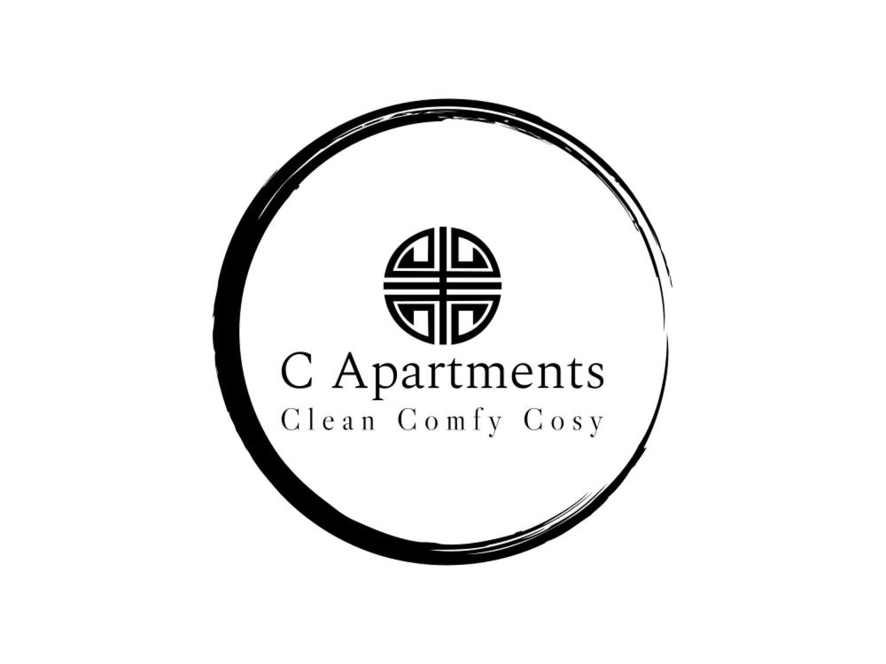 a black and white c apartments clean county cosy logo em C Apartments em Melissátika